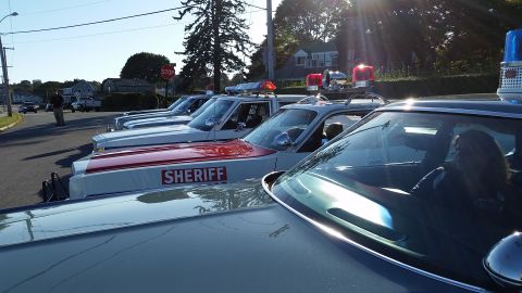 1991 Ford LTD Crown Victoria - Multiple sheriff's vehicles lined up on a street under a sunny sky.