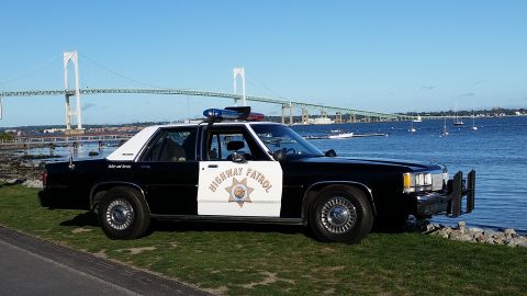 1991 Ford LTD Crown Victoria - Side view of a 1991 Ford Crown Victoria police car with 'Highway Patrol' on the door.