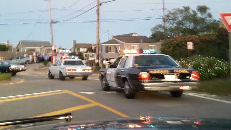 State Highway Patrol cruiser and other police cars on a coastal street