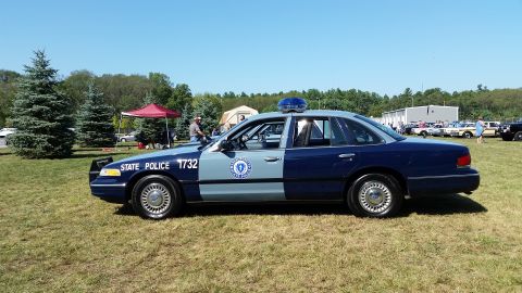 1991 Ford LTD Crown Victoria - Side-view photo of a Massachusetts State Police Ford Crown Victoria cruiser displayed on grass at a car show.