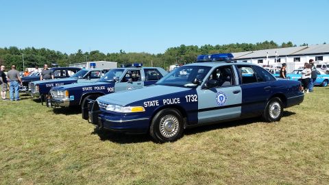 1991 Ford LTD Crown Victoria - Photo of multiple Massachusetts State Police Ford Crown Victoria cruisers parked in a row at a car show.