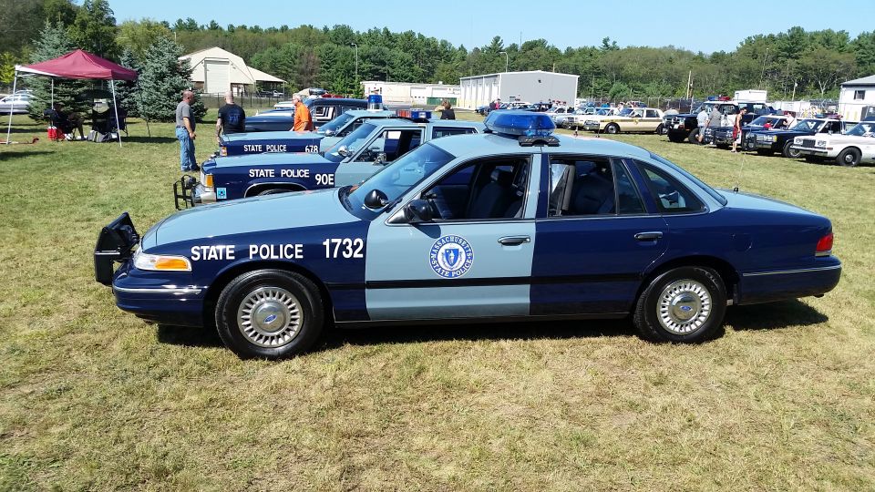 Massachusetts State Police Ford Crown Victoria sedan, number 1732, parked on grass.