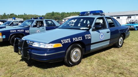1991 Ford LTD Crown Victoria - A dark blue and light blue Ford Crown Victoria police car is parked on a grassy field. The car has "STATE POLICE 1732" written on the side…