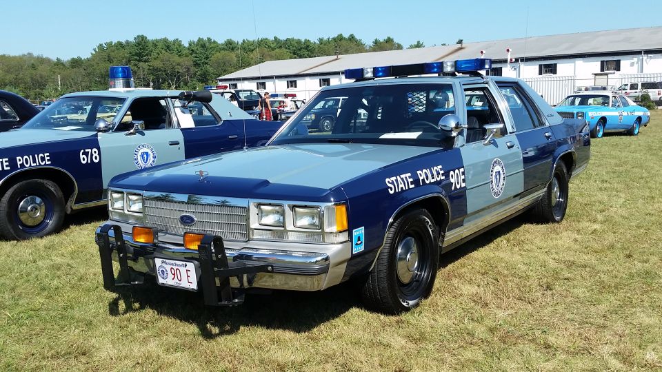 1991 Ford Crown Victoria State Police car, blue and grey, with "STATE POLICE 90E" visible.