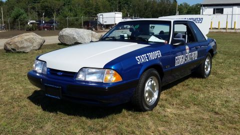 1991 Ford LTD Crown Victoria - A blue and white 1991 Ford Mustang LX SSP police car is parked on a grassy field. The car has "STATE TROOPER" and "GEORGIA STATE PATROL" te…