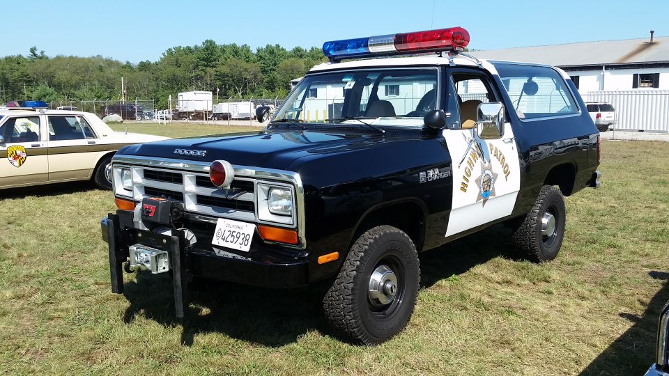 Black and white Dodge Ramcharger police SUV with light bar and winch