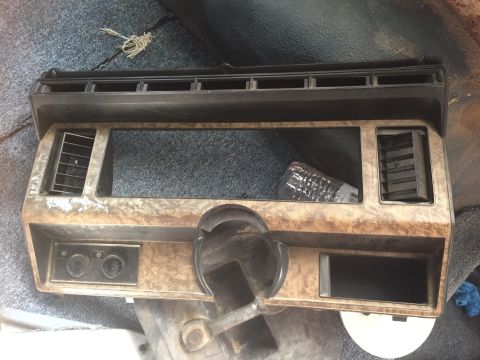 1986 Ford Bronco - This is a close-up of a vehicle's dashboard trim, showing vents and openings for controls.