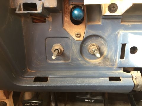 1986 Ford Bronco - Close-up of dashboard controls, including knobs, a switch, and a blue spherical object. Text labels are visible.