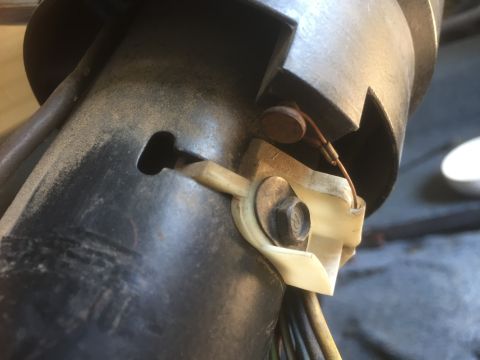 1986 Ford Bronco - Detail of electrical connections and mounting hardware on a vehicle's steering column assembly.