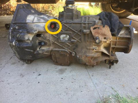1986 Ford Bronco - Close-up view of a transmission with a red cap circled in yellow. The registry claims it is from a 1986 Ford Bronco.