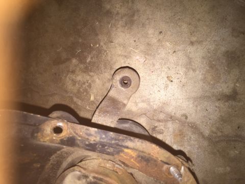1986 Ford Bronco - Close-up view of a rusty undercarriage component with visible hardware.