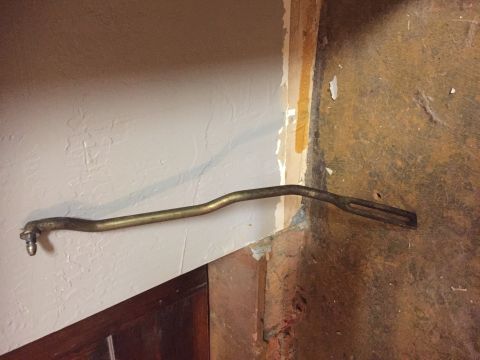 1986 Ford Bronco - A metal rod with a ball joint on one end and a slotted end on the other is shown.