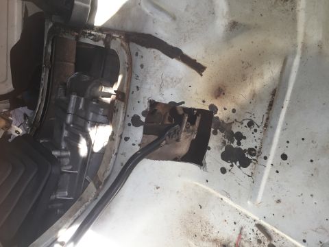 1986 Ford Bronco - Close-up view of the transmission tunnel area, showing wear and tear.