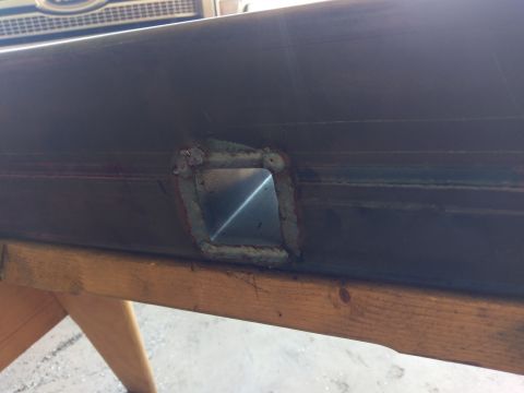 1988 Ford Bronco - Close-up of a square opening cut into a metal tube, with visible welding marks.