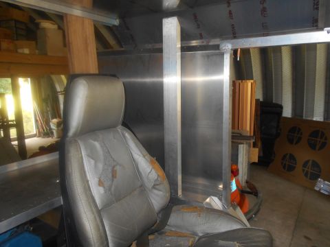 1992 Ford Bronco - A worn car seat is visible inside a structure with unfinished walls and ceiling.