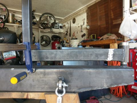 1988 Ford Bronco - Metal fabrication in progress, showing a clamped frame and workshop background.