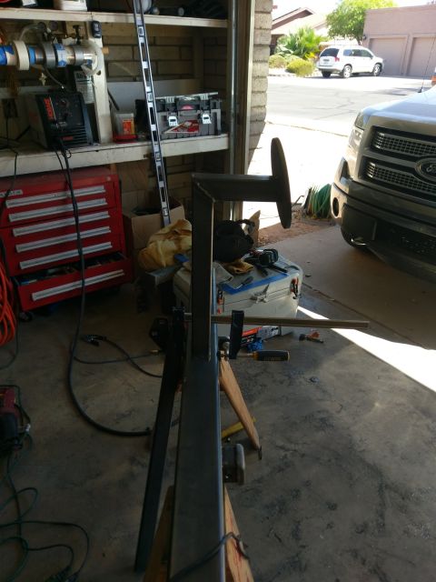 1988 Ford Bronco - Garage interior with metal fabrication equipment and vehicles visible through the open door.