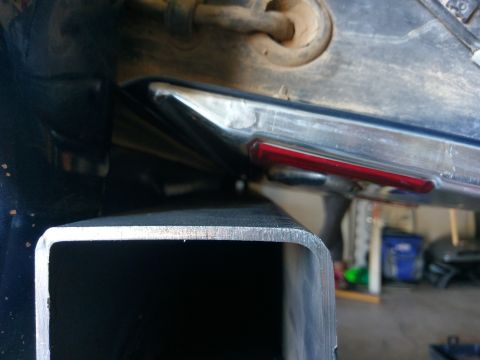 1988 Ford Bronco - Trailer hitch receiver shown in front of a vehicle's rear bumper, with a red reflector visible.