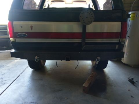 1988 Ford Bronco - The rear of a Ford Bronco shows a custom bumper and spare tire mount.