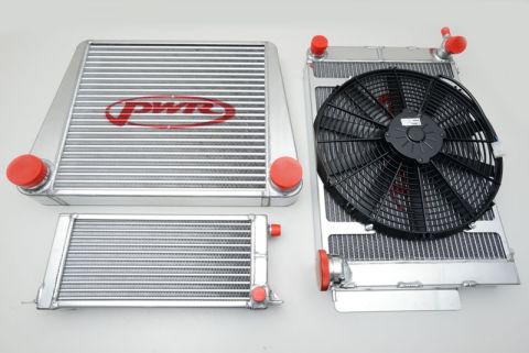 1973 Mazda RX-3 - Three aluminum radiators, one with a PWR logo and a fan, are displayed against a white background.