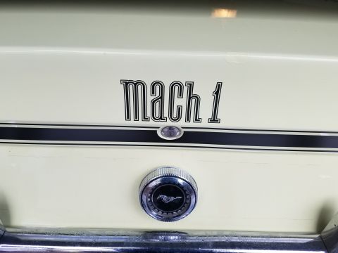 1971 Ford Mustang - Close-up of the rear of a 1971 Ford Mustang Mach 1, showing the emblem and gas cap.