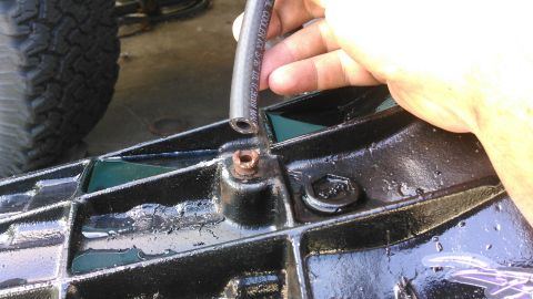 1996 Ford Bronco - just incase i offroad in water thats too high, i decided to run a breather hose. only really doable with tranny pulled. the vent has a loos…