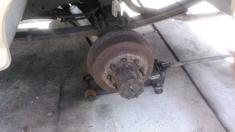 1990 Ford F-250 - chock front tires and jack up and remove tire