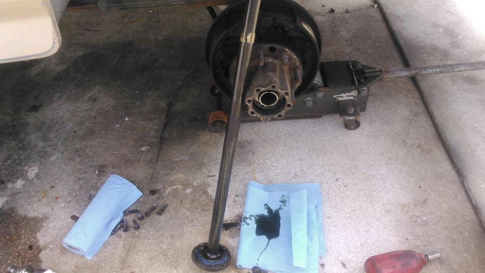 number one: make sure you have enough room to slide the axle shaft out. i made that mystake on the passenger side and had to reassembly everything enough to roll it where i can slide it out

remove the 8 flange bolts and pull the flange out. 

gear oil will come out so be prepared to catch it. the higher the axle is angled the less gear oil that will ooze out.