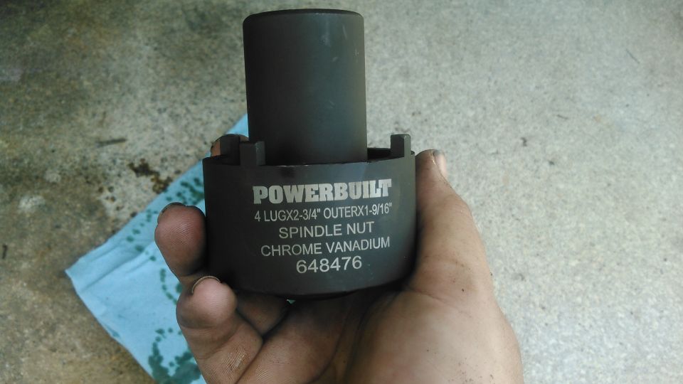 to remove the hub you need to have a 4-point spindle nut tool. this is the cheapest one i could find.

i am not sure if the 4-point spindle socket for the front axle will work