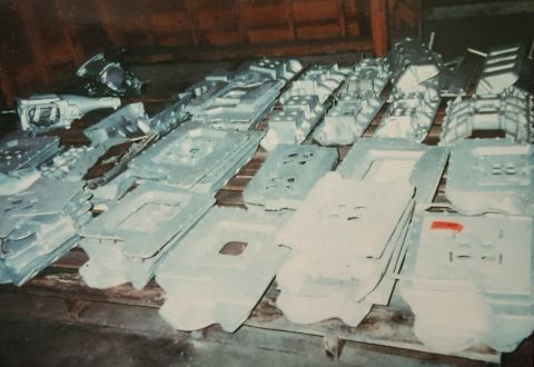 1973 Ford Mustang - Numerous automotive parts, possibly transmissions and engine components, are stored in an attic space.