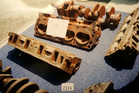 1973 Ford Mustang - Various engine components are laid out on a blue carpeted surface, with a handwritten note on one part.