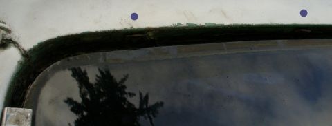1992 Ford Bronco - Windshield header trim removal. Purple dots show where the metal clips are hiding in the shadows. They snap onto little round tabs on the r…