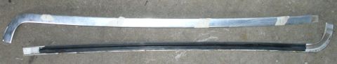 1992 Ford Bronco - Windshield header trim removal. The 4 tape marks on the top side piece show where the tabs are located (both sides are symmetric).