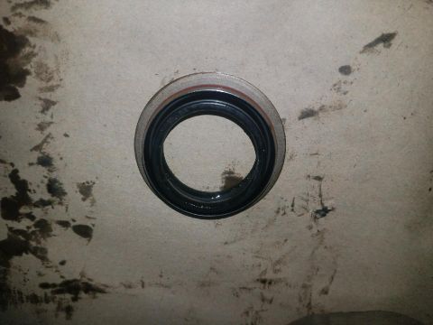 1987 Suzuki Samurai - Close-up of an oil seal, likely for automotive use, on a dirty surface.
