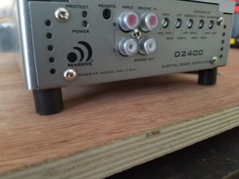 1994 Ford Bronco - Close-up of a car stereo amplifier, showing its rear panel with various input and output connections.