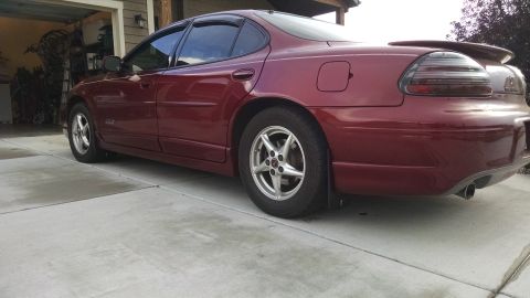 2002 Pontiac Grand Prix - This red 2002 Pontiac Grand Prix is shown from the rear quarter angle.