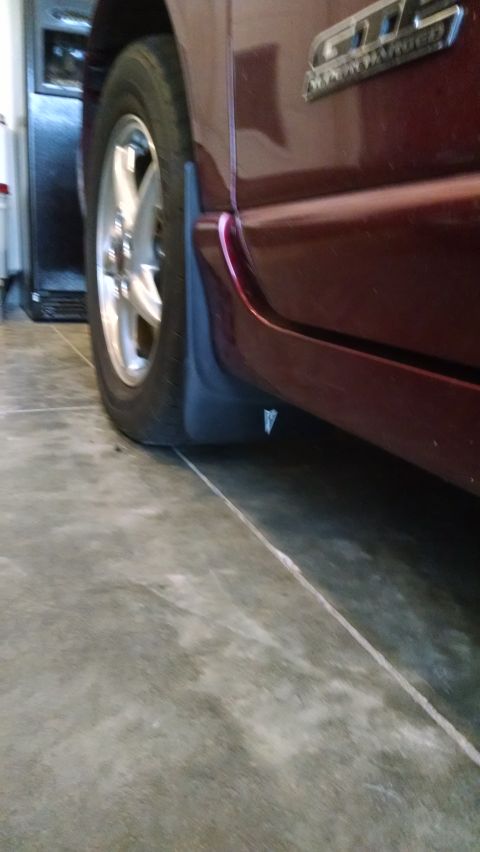 2002 Pontiac Grand Prix - A dark red vehicle's rear wheel and splash guard are visible, with 'GTP' badging on the body.