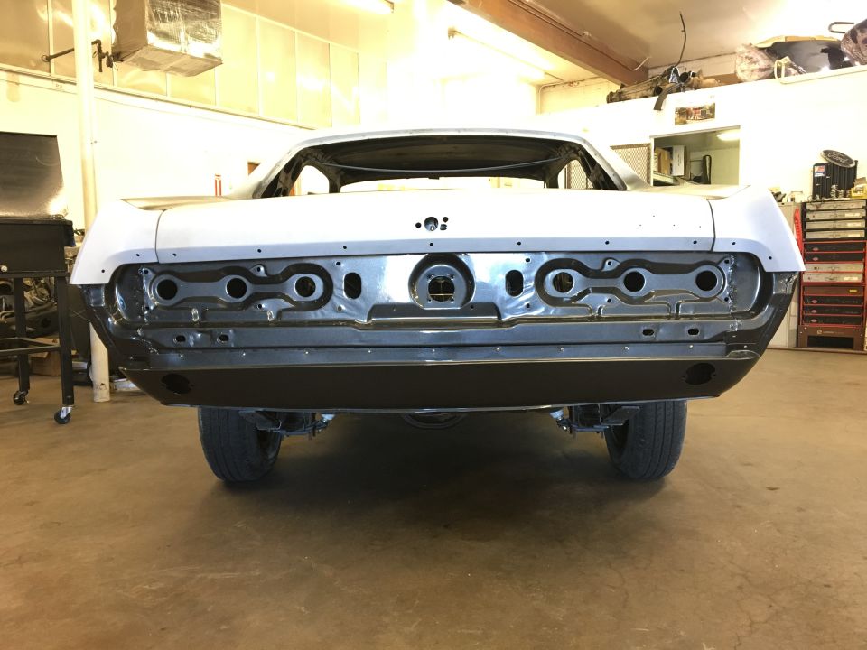 Rear of a 1967 Mercury Cougar undergoing restoration, showing the taillight housings and bumper area removed