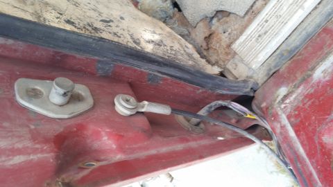 1981 Ford Bronco - Detail of a vehicle's door latch and wiring, with visible rust and wear.