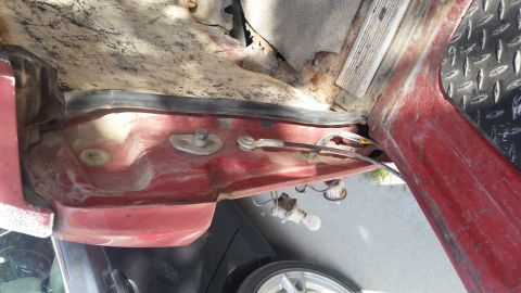 1981 Ford Bronco - Close-up of damaged vehicle interior showing rust and exposed components.