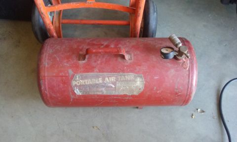 1995 Ford Bronco - Portable air tank with gauge and valve, positioned on a hand truck.