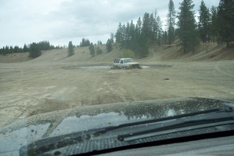 1995 Ford Bronco - White 1995 Ford Bronco navigating a muddy off-road course.