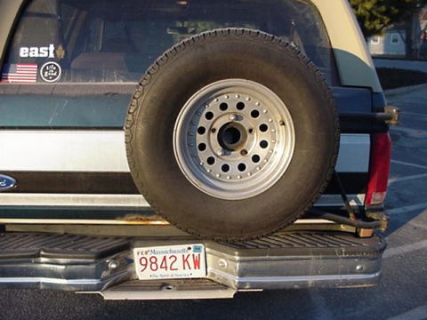 1994 Ford Bronco - Rear view of a 1994 Ford Bronco showing the spare tire and license plate.