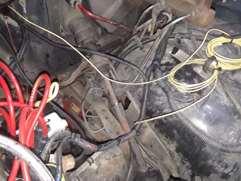 1985 Ford Bronco - A close-up view of complex wiring within a vehicle's engine bay.