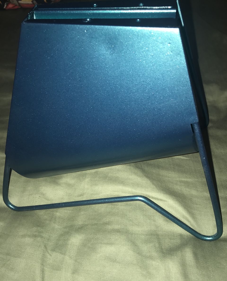 Blue metallic part with wire legs, seen from the side