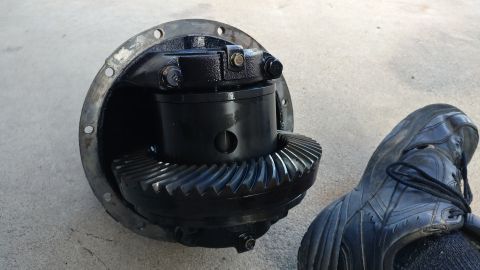 2002 Mitsubishi Montero Sport - Differential gear assembly shown next to a shoe on a concrete surface.