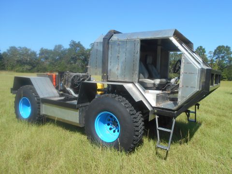 1992 Ford Bronco - This custom-built vehicle features a unique metallic body and large off-road tires.