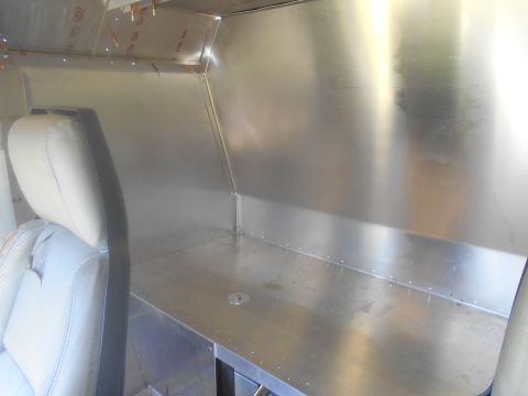 1992 Ford Bronco - Vehicle interior with custom aluminum paneling and a single seat visible.