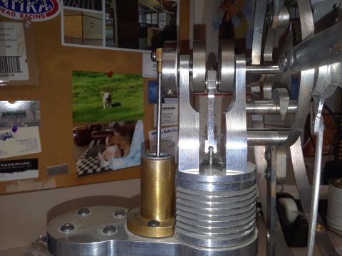 1994 Ford Bronco - Model engine mechanism with background photos and labels on a corkboard.