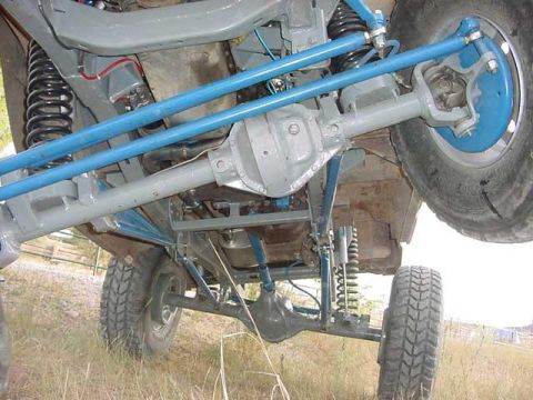 1978 Ford Bronco - The underside of a vehicle is shown, highlighting its suspension and drivetrain components.